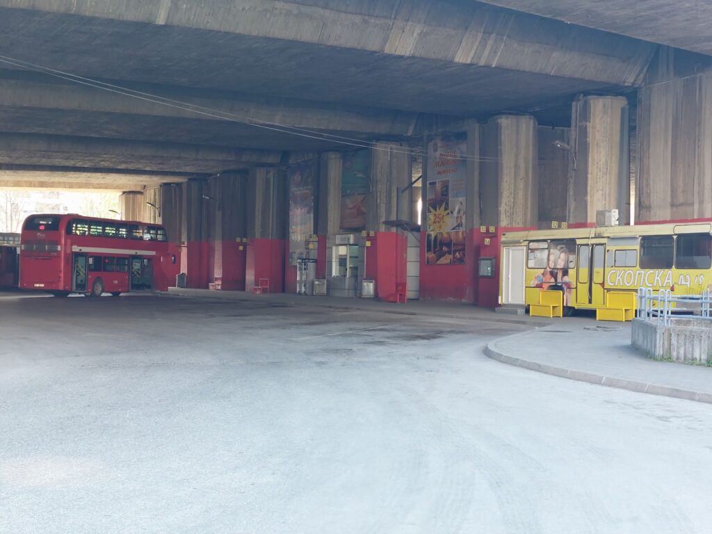 Red double decker bus to Vodno, Millennium Cross and yellow bus ticket office, At bus station under the train station. Skopje